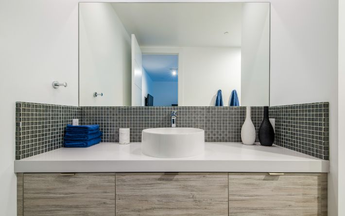 White and blue bathroom with white basin and mirror